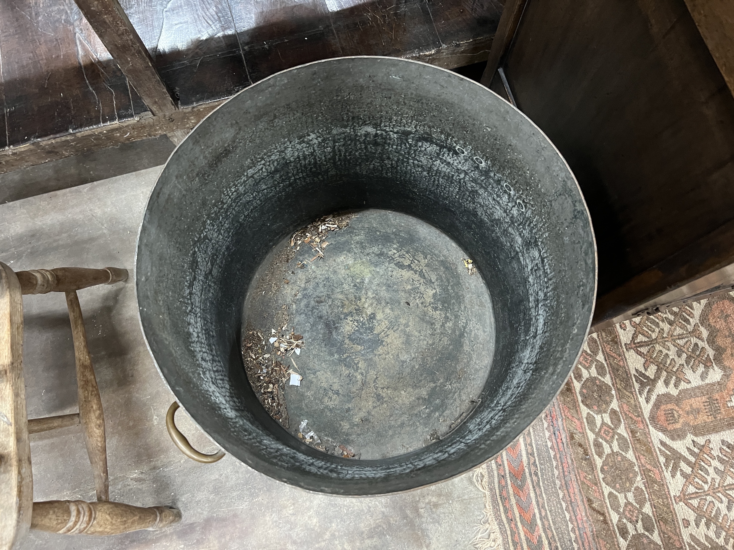 A large Victorian circular hammered copper cauldron with brass spigot, diameter 52cm, height 52cm